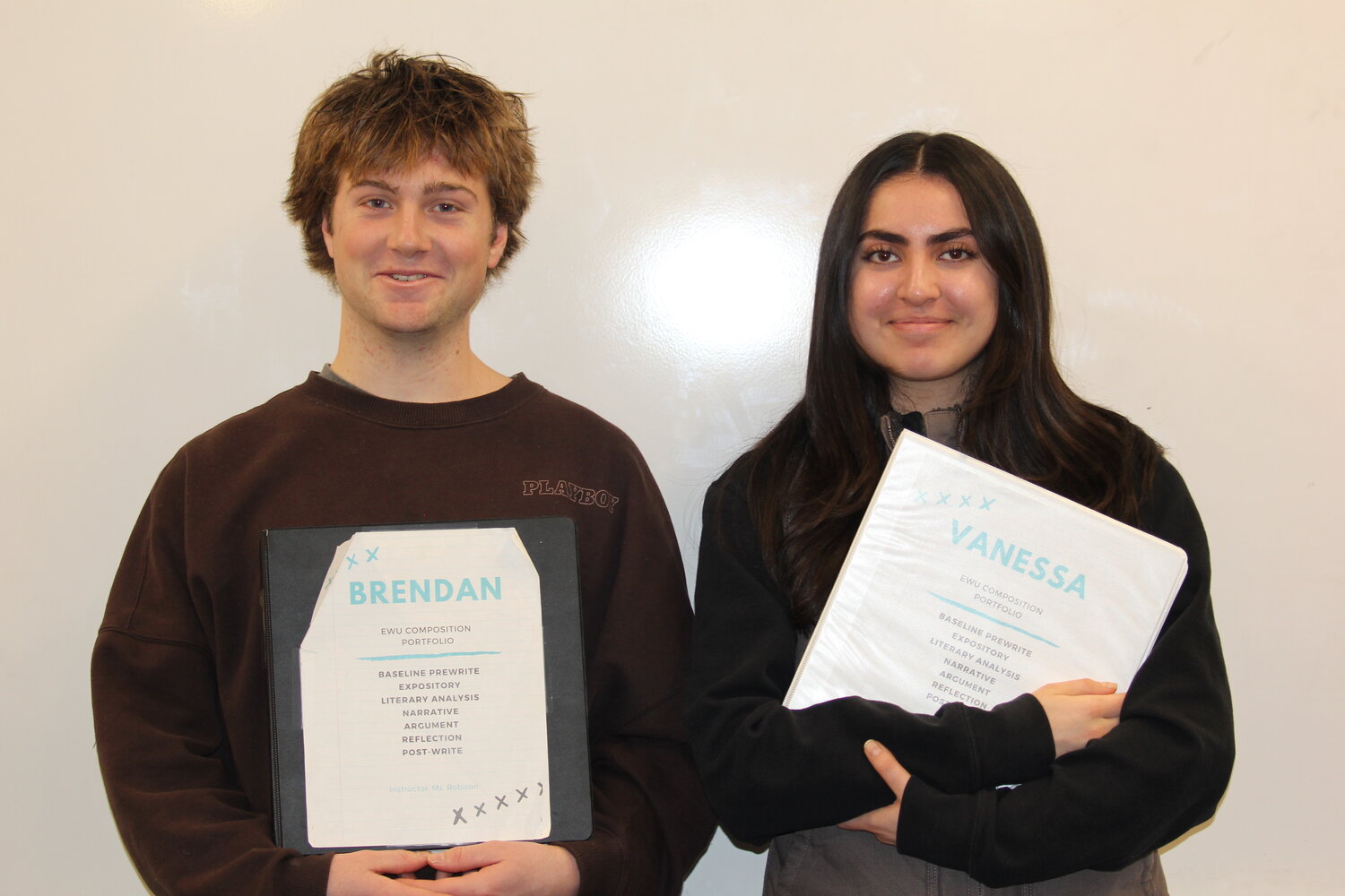 Seniors Brendan Fallon and Vanessa West pose with writing portfolios from a college level course they took while enrolled at CHS.  Both will graduate from Cascade High School with over 40 college credits. Photo Credit: Maddy Black