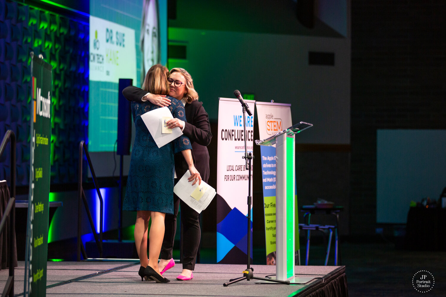 Outgoing NCW Tech Alliance Executive Director Jenny Rojanasthien embraces Dr. Sue Kane, the new CEO of NCW Tech Alliance.
