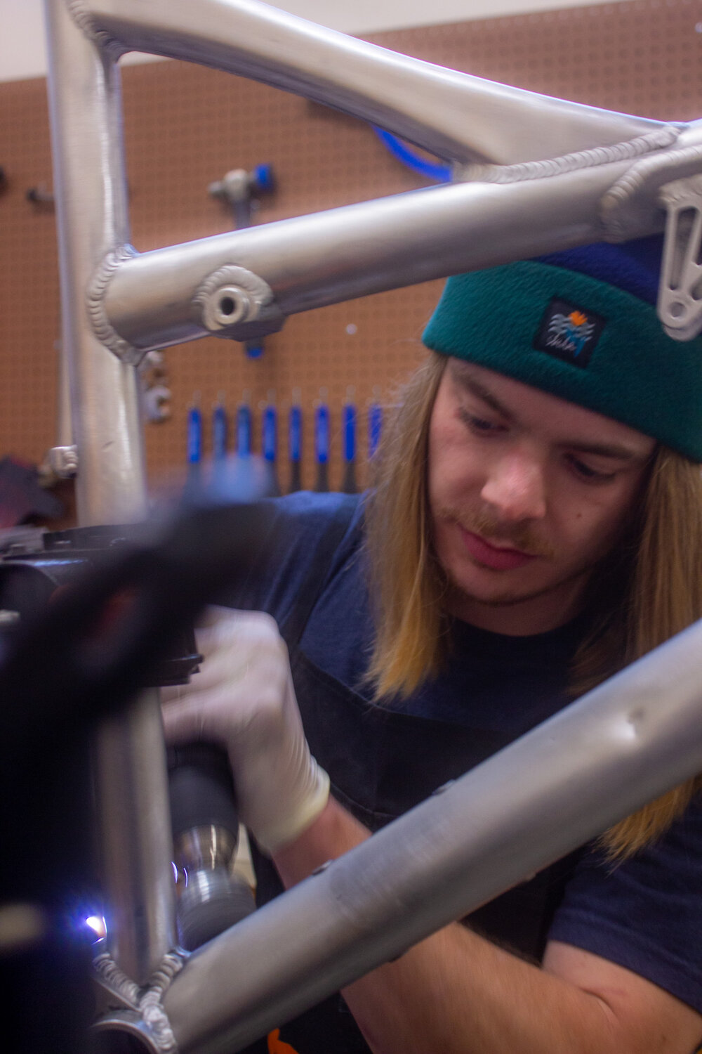 Andrew Blacketer, Eastside Cycleworks’ lead bike mechanic, working on a bike frame.