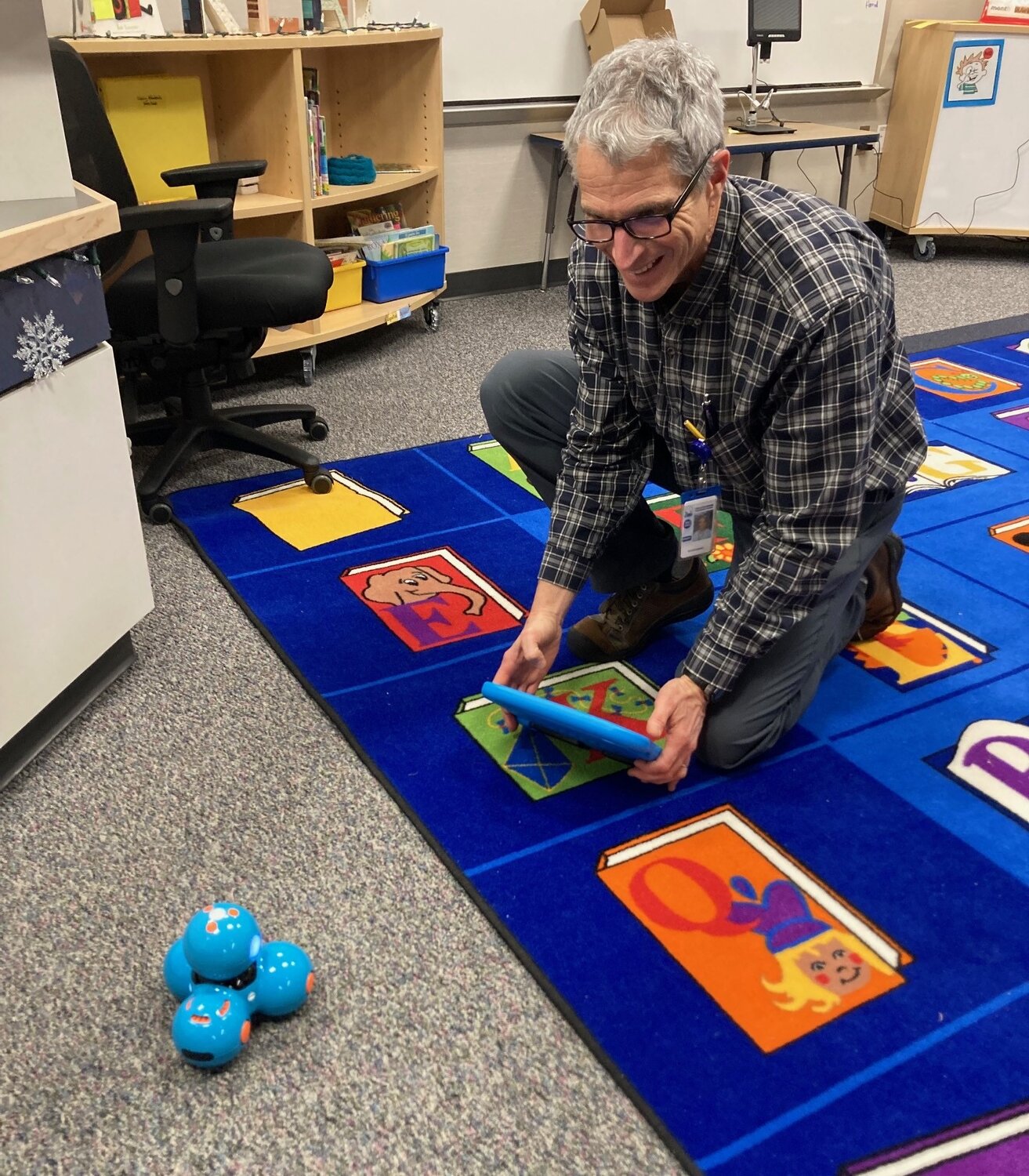 Second grade teacher Peter Spiegel tries out a Dash robot.