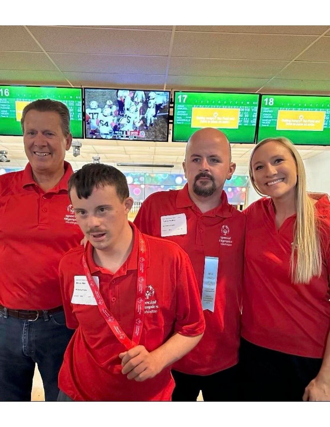 Chelan Special Olympics athletes pose with their coaches at a bowling competition. From left to right are assistant coach Steve Hilde, athlete Michael Hilde, athlete Trenton Hudkins, and coach Brooke Sanders.