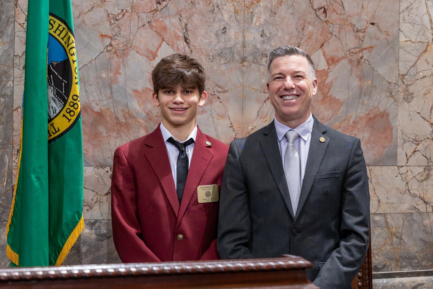 Cashmere High School sophomore Isaac Zavala (left) stands with 12th Legislative District Senator Brad Hawkins at the Capitol in Olympia, where Zavala served as a Senate page during the fourth week of the 2024 Legislative session. Isaac, who was sponsored by Senator Hawkins, gained firsthand experience in the legislative process, participating in floor voting and learning about parliamentary procedures.