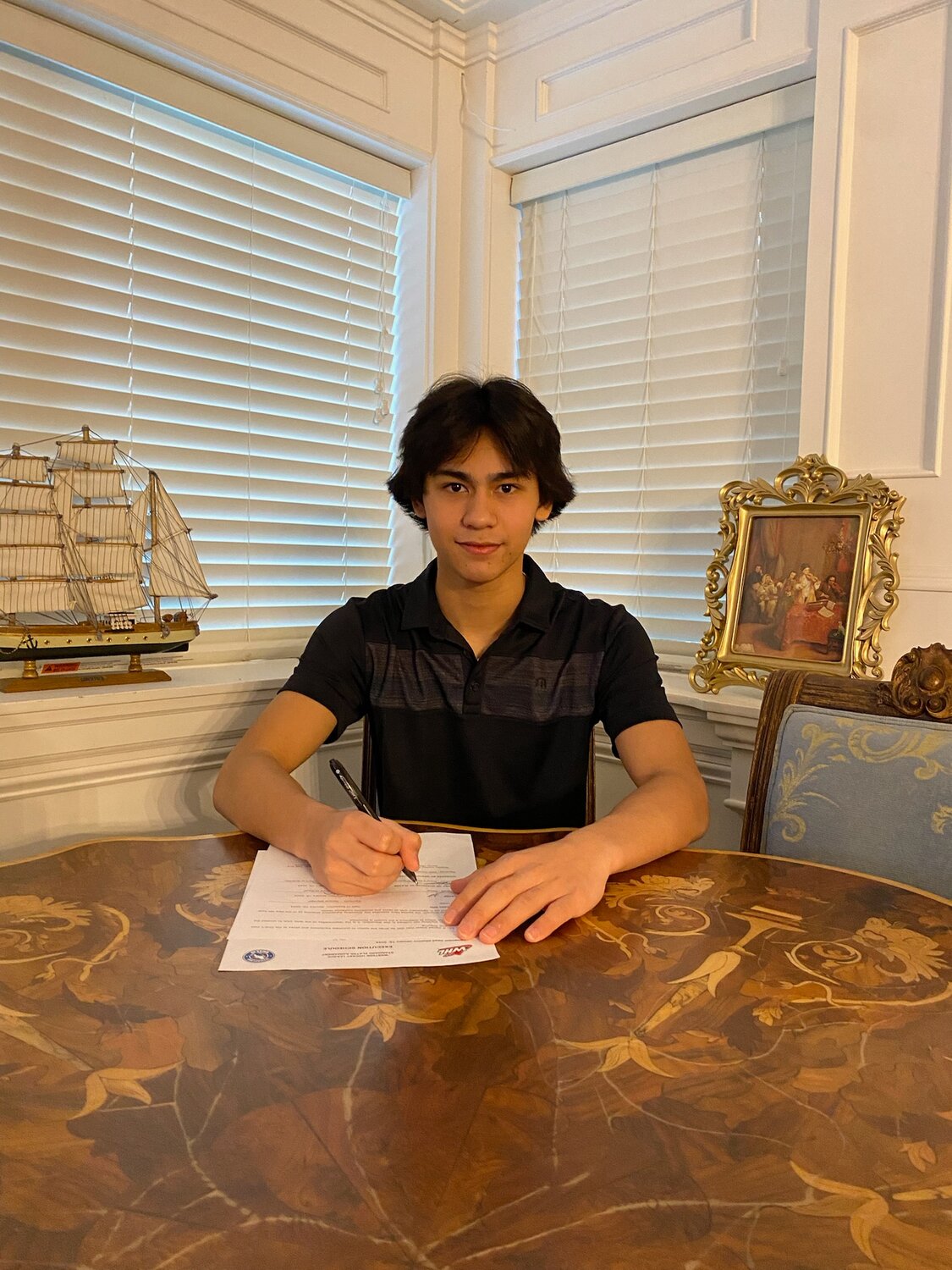 Delta Hockey Academy forward Nathaniel Danielson signs his Scholarship and Development Agreement with the Wenatchee Wild of the Western Hockey League.