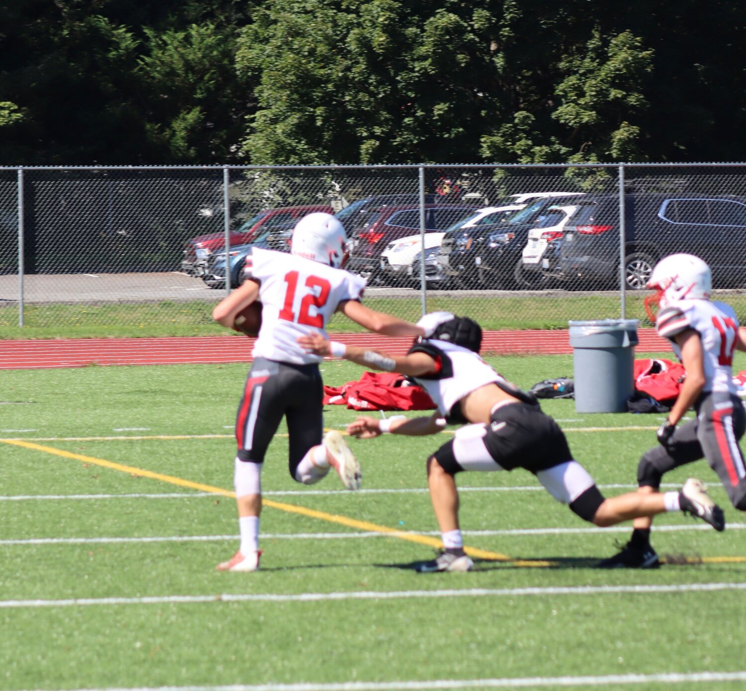 Sophomore Julian Feeney delivers a powerful, stiff arm to Coupeville's linebacker as he runs into the end zone, gaining the Kodiaks a much-needed 6 points.