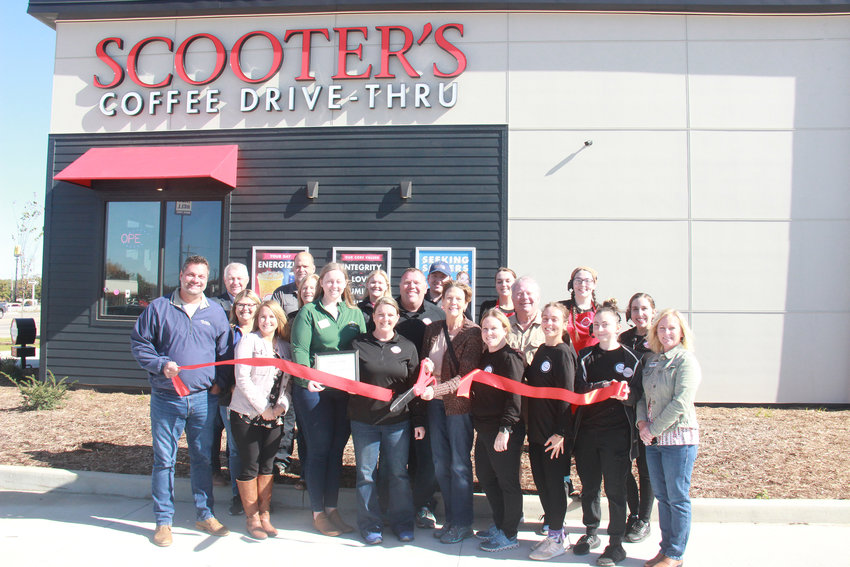 The owning family and employees of the new Scooter's drive-thru coffee shop in Warrenton hosted guests from the city government and local business community for a ceremonial ribbon cutting on Oct. 14, 2022, to celebrate the store's opening.