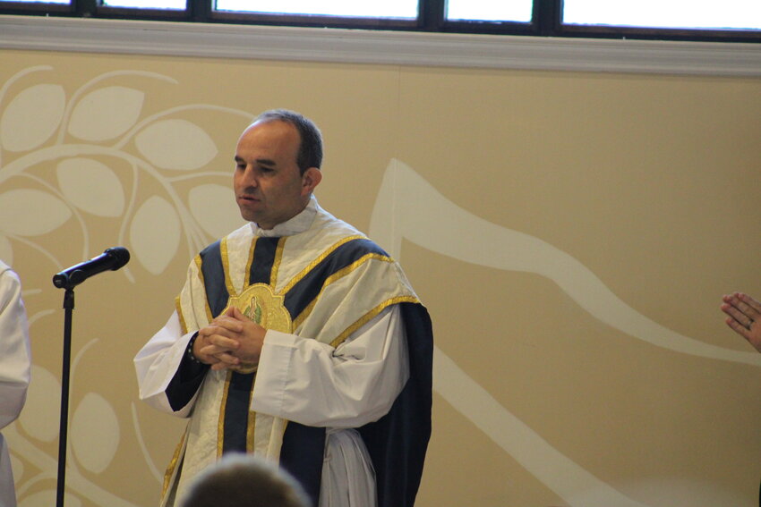 Father Eddie speaks during the 8 a.m. Mass on Aug. 22 at Holy Rosary.