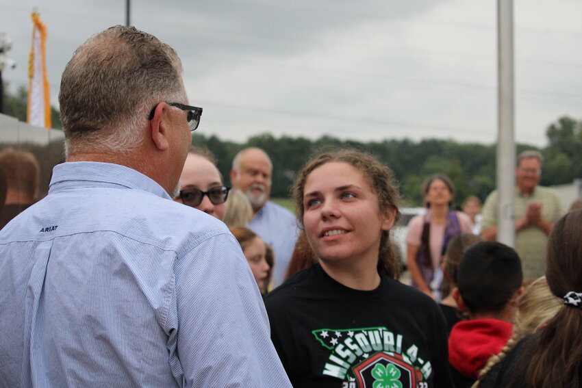 Madison Dent talks with Warren County Presiding Commisioner Joe Gildehaus after the Sept. 11 ceremony.