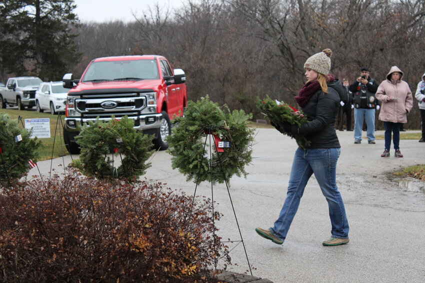 McKenna Jones carries the wreath to honor the U.S. Coast Guard during the Wreaths Across America ceremony Dec. 16 at the Warrenton City Cemetery.
