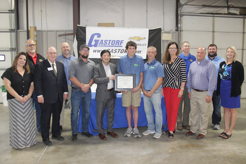 CELEBRATED APPRENTICE &mdash; Wright City&rsquo;s Shane Sargent, center, receives a U.S. Department of Labor Certificate of Completion of Apprenticeship during a small ceremony at the Gastorf Chevrolet body shop on May 28. Pictured with him are representatives of Gastorf, Four Rivers Career Center, Wright City School District, and state government officials. Presenting the certificate was Wade Johnson with the U.S. Department of Labor.     Adam Rollins photo.
