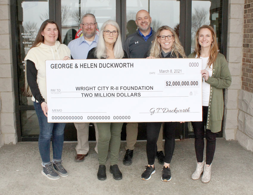 WRIGHT CITY SCHOLARSHIPS &mdash; The Wright City R-II School District recently received a donation of $2 million from the Duckworth Trust to go toward student scholarships. Pictured in front, from left, are Wright City Scholarship Foundation member Brook Ramey, Duckworth Trust representative Shawn McCord, Wright City Foundation members Jennie Bueneman and Brooke Shaw. In back are Wright City Foundation member A.J. Girondo and R-II Superintendent Dr. Chris Berger.      Derrick Forsythe photo.