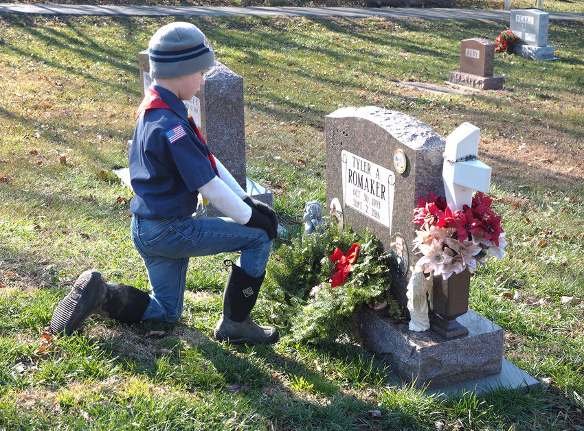 MOMENT OF SILENCE &mdash; As Matthew O&rsquo;Brien honored Tyler Romaker at the Holy Rosary Cemetery, he spoke Romaker&rsquo;s name aloud, and paused for a moment of silence during the annual Wreaths Across America event held Saturday, Dec. 19. Both the Warrenton City Cemetery and Holy Rosary Cemetery hosted the laying of wreaths on all veterans graves. Warrenton was one of 2,100 locations involved in the nationwide effort.	Cindy Gladden photo.
