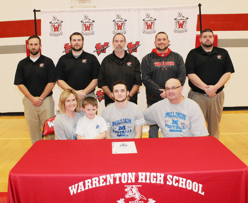 COLLEGE COMMITMENT — Warrenton senior Nolan Chmiel, pictured front row, center, signed his letter of intent to play football for Milliken University in Illinois on Monday. Also pictured, front row, left to right, are Kelly Chmiel, mother; Aiden Chmiel, nephew and Ray Chmiel, father. Back row — Defensive Coordinator Jason Koper, Defensive Line Coach John Jeskey, Head Coach Steve McDowell, Offensive Coordinator Scott Butler and Coach Dallas Stapp. Derrick Forsythe photo.