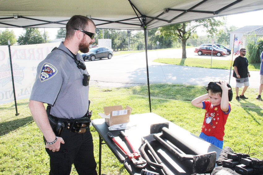 This file photo shows a police officer interacting with a young visitor at the National Night Out event in 2019 in Truesdale. This year the city of Warrenton is hosting a National Night Out event at the athletic complex on Hickory Lick Road.