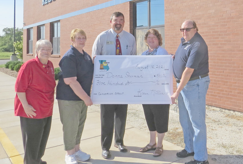 Rebecca Boone Elementary teacher Donna Sherman, second from right, receives a $500 classroom grant from the Missouri Retired Teachers Foundation. With her, from left, are retired teachers association members Sherry Brandes and Marsha Burns, Principal Steve Weeks, and association member Guy Schreck.