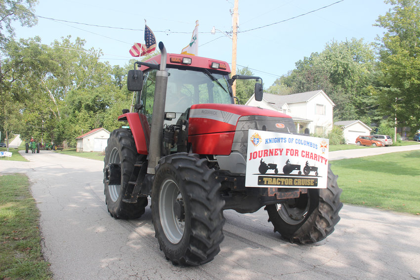 TRACTOR CRUISE &mdash; A tractor leads the procession of the Journey For Charity tractor cruise as it passes through Marthasville in September 2020.