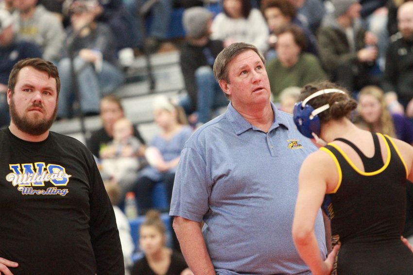 Wright City Wrestling Coach Fred Ross coaches Elizabeth Riggs during the girls district wrestling tournament. Ross coached three wrestlers to the state tourney this year.