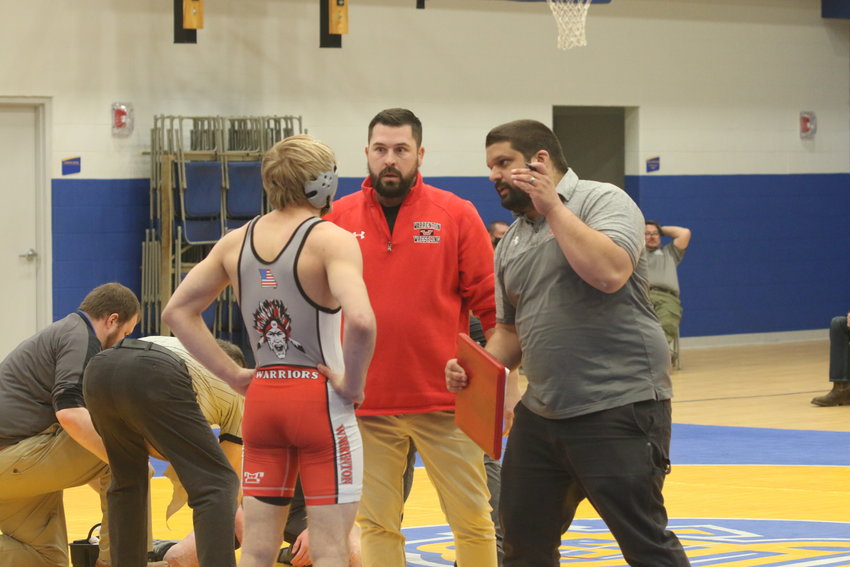 Warrenton wrestling coach Clayton Olsson (right) coaches Levi Penrod during a match earlier this year. Penrod was one of seven Warrenton boys wrestlers to qualify for the state tournament this season.