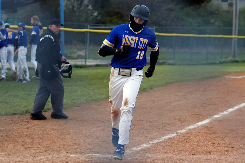 Ian Wolff crosses home plate after hitting a game-tying home run in the seventh inning. Wolff hit the home run with two outs.