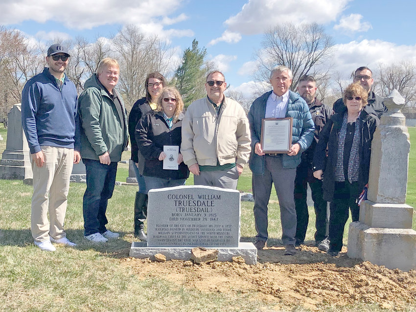 HONORING THE FOUNDER &mdash; Representatives of Truesdale traveled to Bunker Hill, Ill., on April 9, to unveil a new gravestone for town founder William Truesdail, paid for by community fundraising. Pictured, from left, are Aldermen Joe Brooks and Mike Thomas, City Clerk Elsa Smith-Fernandez, Treasurer Missy Bachamp, Alderman Jerry Cannon, Truesdail descendent Steve Williams, Police Chief Casey Doyle, former Clerk MaryLou Rainwater, and Officer J. Malta.