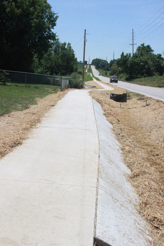FRESH SIDEWALK &mdash; A newly poured section of sidewalk at Columbus Circle is part of recently completed paving connecting the north end of Warrenton to the I-70 corridor.