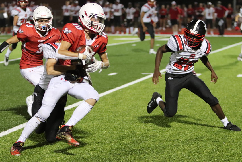 Warrenton wide receiver Mason Thompson (10) attempts to elude Ft. Zumwalt South defenders during Friday&rsquo;s season opener.