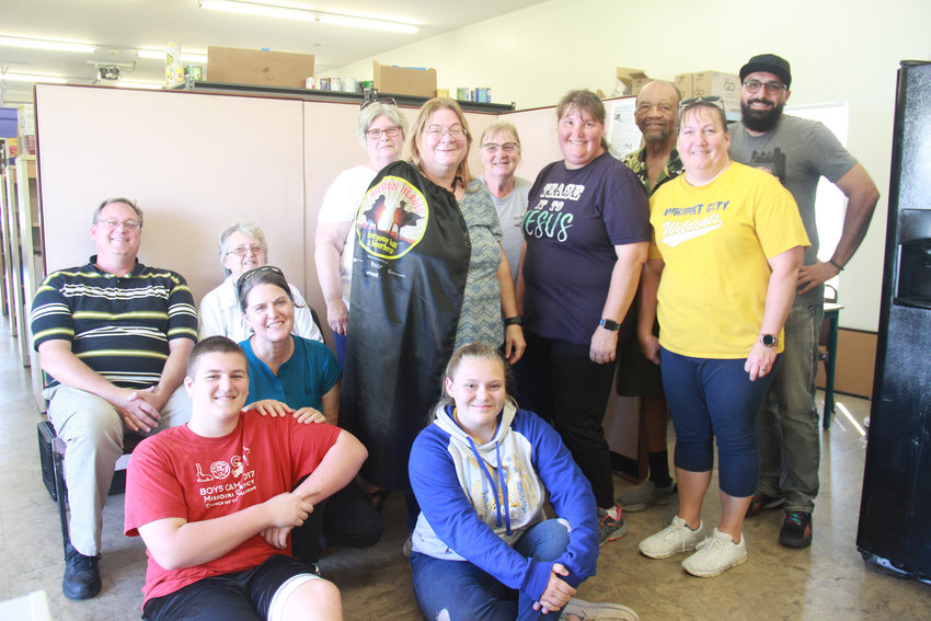 OUR OWN HERO &mdash; Family members and fellow volunteers at the Wright City Community Food Pantry gathered Aug. 29 to celebrate the contributions of Hidden Hero Alice Windmann, center. Windmann spends multiple days each week helping the pantry provide services to community members in need.