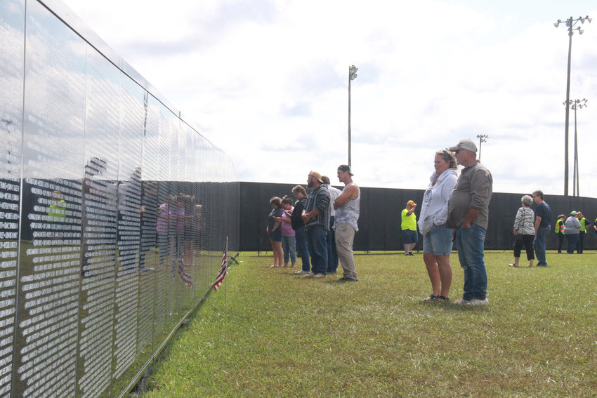 REFLECTION &mdash; Visitors to The Wall That Heals search for the names of family members or friends, or take time to understand the magnitude of the more than 58,000 names listed on the replica of the Vietnam War Memorial. The wall visited Warrenton from Sept. 8-11.