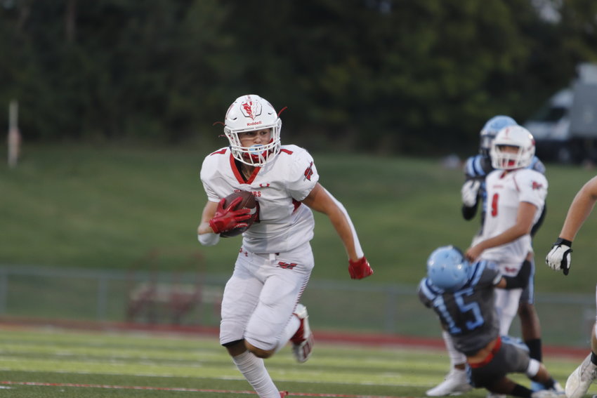 Warrenton running back Austin Haas carries the ball during the first half of Friday's game against St. Charles.