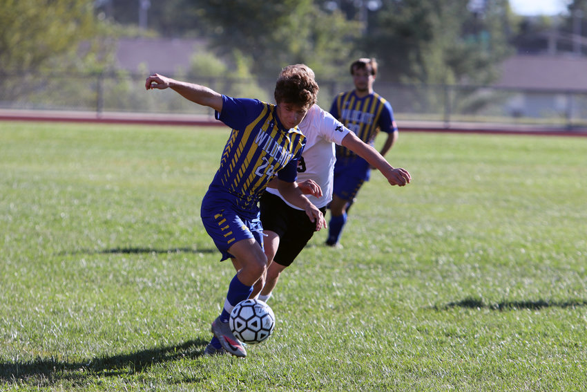 David Riggs (left) possesses the ball as he looks to move upfield during Monday&rsquo;s game against St. Louis Christian.