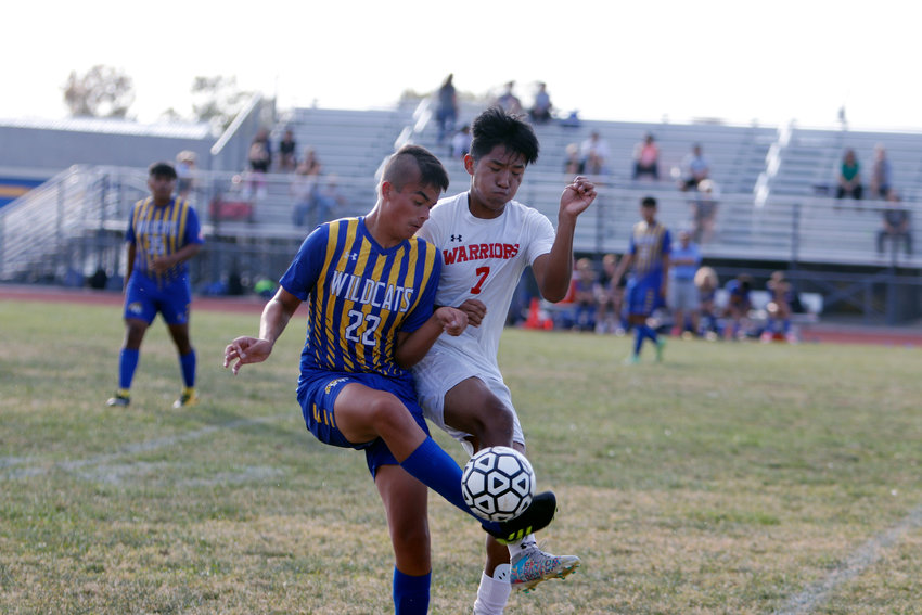 Wright City defender Aaron Simon (left) and Warrenton forward Santiago Cano battle for possession of the ball during the first half of Monday&rsquo;s game at Wright City. Warrenton won the game 3-2.