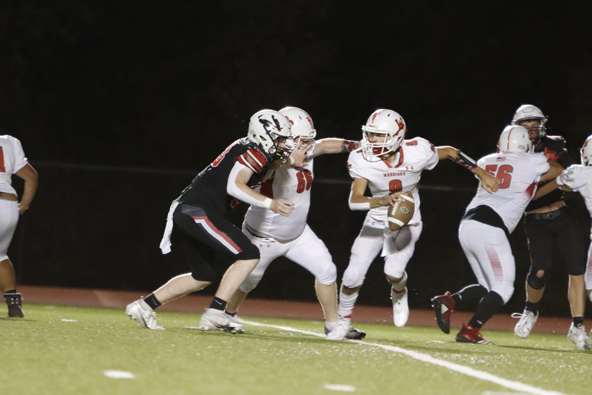 Charlie Blondin eludes the Winfield pass rush during the first quarter of Friday&rsquo;s win.