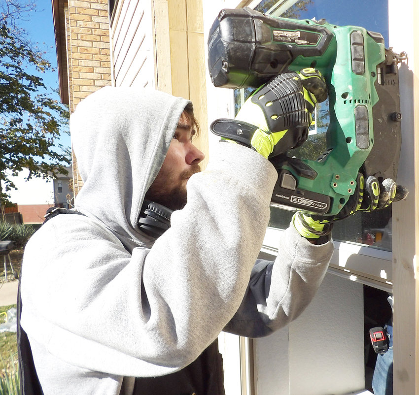 North East Community Action Corporation (NECAC) Weatherization Specialist Andy Mackey installs a window at the Wright City Apartments.