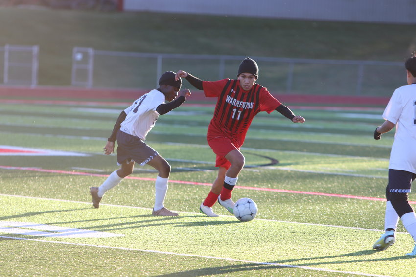 Bryan Guerrero (right) looks to move upfield during a regular season game against St. Charles earlier this season. Guerrero was named to the GAC North first team.