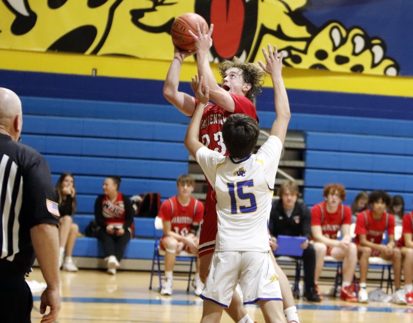 Warrenton senior Kannon Hibbs (23) prepares to shoot the ball over Wright City junior Jerry Stanford during the second half of Warrenton&rsquo;s win over Wright City last Friday.