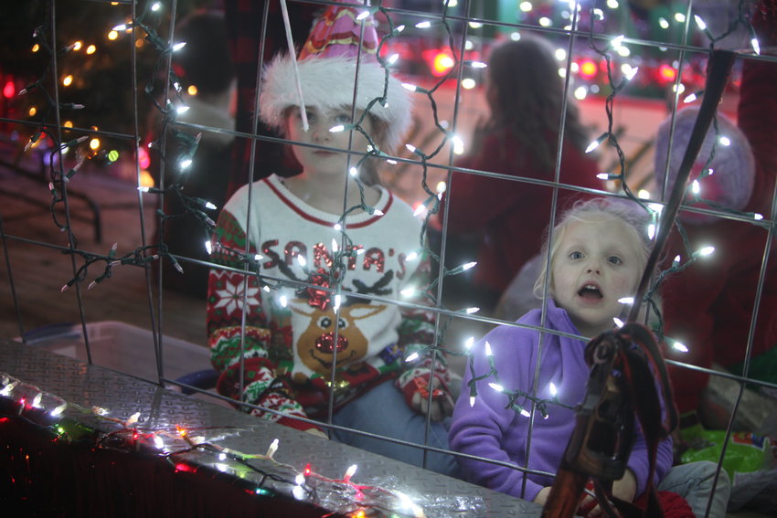 Two children enjoy the Jonesburg Lighted Christmas Parade in 2021. The 12th annual event is scheduled to start at 6 p.m. on Dec. 2 at the St. Patrick&rsquo;s Catholic Church parking lot.