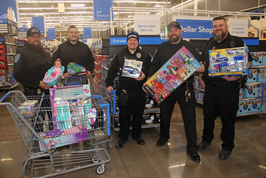 SPREADING CHEER &mdash; Truesdale police officers show off the first batch of presents purchased for kids in need thanks to community donations. Officers with Truesdale and Warren County took local children on shopping trips to Walmart to help form positive connections with their community.