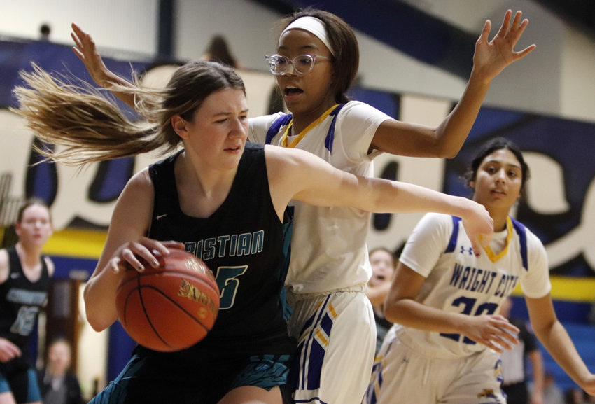 Wright City sophomore Danika Graham (middle) defends O&rsquo;Fallon Christian&rsquo;s Abby Pils (left) during the first half of Wright City&rsquo;s 34-24 win last week.