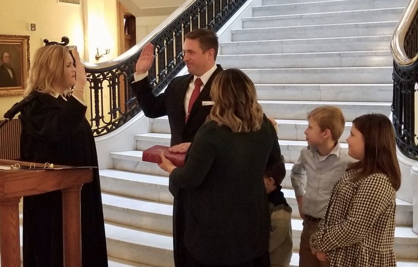 Attorney General Andrew Bailey is sworn into office Tuesday in Jefferson City by Judge Kelly Broniec of the Eastern District Missouri Court of Appeals, while his wife and children look on.