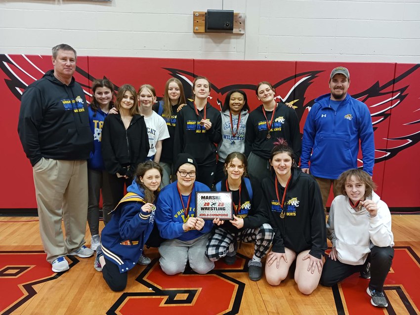 Members of the Wright City girls wrestling team pose with the Marshall Tournament championship plaque.