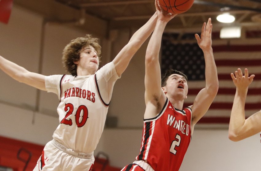 Troy Anderson (left) attempts to block Winfield guard Brady Creech&rsquo;s shot attempt during the second half of Tuesday night&rsquo;s game.