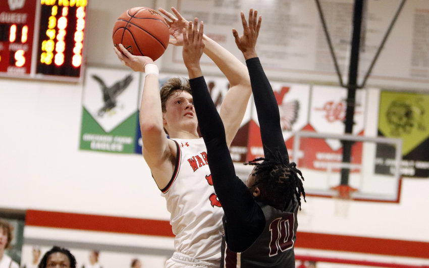 Tyler Oliver shoots over St. Charles West defender Nick Lewis during the first half of Friday night&rsquo;s game. Oliver led Warrenton with 11 points.