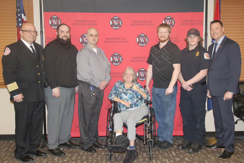CITIZEN HEROES &mdash; Truesdale resident Connie Hall, center, got to thank the neighbors who saved her life from a January house fire during a special awards ceremony on March 20. Pictured with Hall, from left, are Warrenton Fire Chief Anthony Hayeslip, neighbors Eric Johns, Adam Biondo, James Galloway and Ashton Dabbs, and State Fire Marshal Tim Bean. Not pictured: James Hilbig.