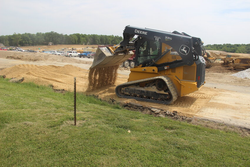 Wright City Director of City Services Kyle Roettger uses heavy machinery to fill some of the damaged sections of Roelker Road with gravel.