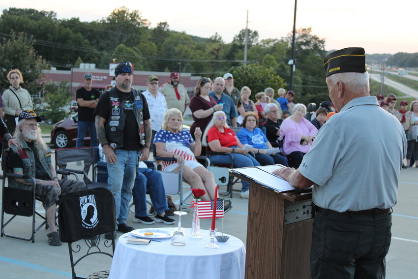 A man stands at attention during Gary Ruebling's keynote address at the ceremony to honor America's POW/MIAs.