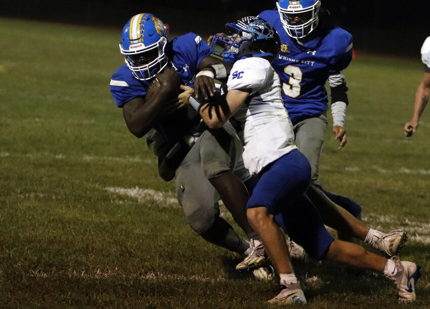 Carle'on Jones (left) attempts to break a tackle in a game against South Callaway earlier this season.