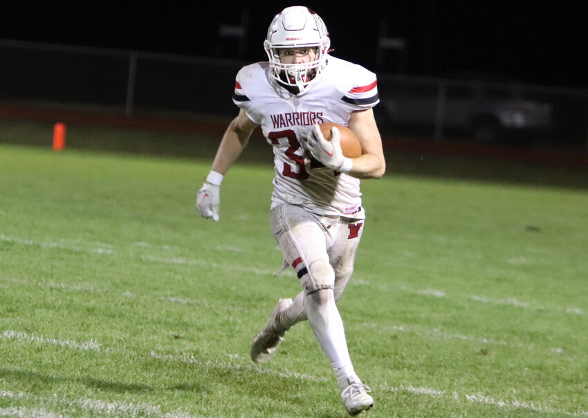 Joe Goldsmith runs towards the Orchard Farm end zone after intercepting a pass in the fourth quarter of Warrenton's win over Orchard Farm.