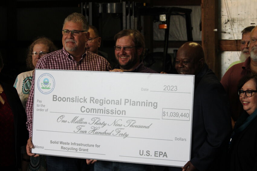 Warren County Presiding Commissioner Joe Gildehaus, Boonslick Regional Planning Commission Chairman Ryan Poston, and EPA Region 7 Brownfields, Redevelopment and Reuse Branch Chief Stan Walker hold the ceremonial oversized check for $1,039,440 that was presented to Boonslick Regional Planning Commission on Oct. 26 at the East Central Missouri Recycling Center in Warrenton. The Boonslick Regional Planning Commission received the money from the Environmental Protection Agency as part of a Solid Waste Infrastructure Recycling grant. The money will benefit the East Central Solid Waste Management District, which serves Warren, Montgomery, Lincoln and Franklin Counties and will be used to purchase a truck, trailer, styrofoam compactor, and build a new storage house with a concrete driveway. There will also be 20 staffed drop-off locations throughout the four counties to help prevent the need for people to drive to Warrenton with their recycling. A new worker will also be hired to transfer material. &ldquo;The drop off is going to be huge and having better equipment is going to be phenomenal,&rdquo; Gildehaus said.