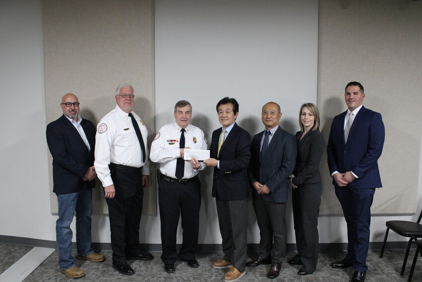 Kikkoman Food Manufacturers makes a donation to the Warrenton Fire Protection District.