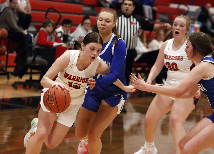 Erin Klasing (left) drives to the basket during Warrenton&rsquo;s home game against Hermann last week.