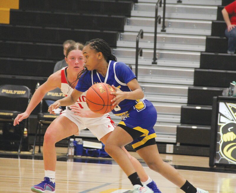 Wright City sophomore Shiriah McRoberts dribbles around Mexico's Jordyn Thurman on Monday in the Class 4 District 8 tournament in Fulton. The Wildcats&rsquo; season ended in a 64-61 loss.